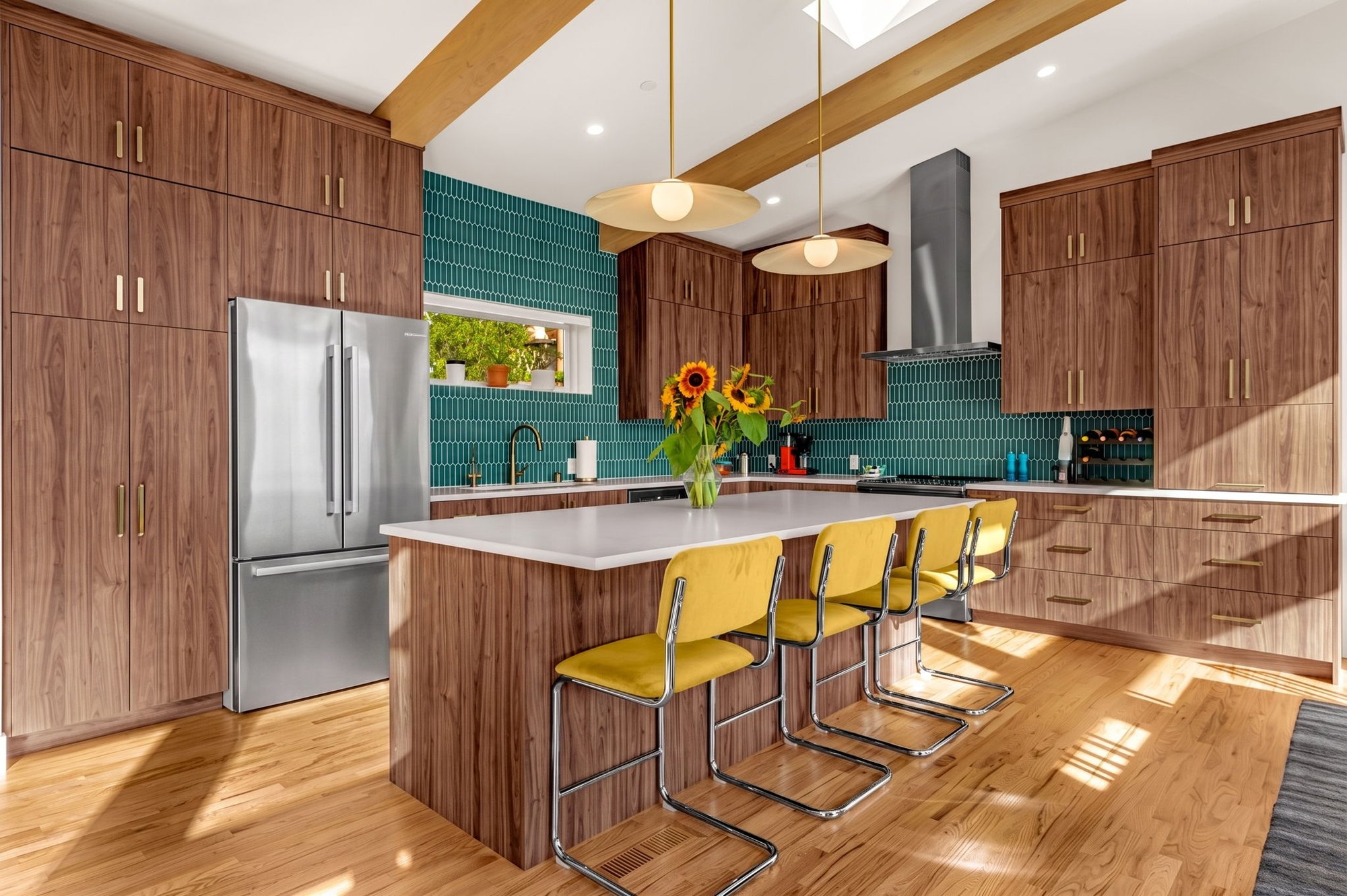 Floor-to-ceiling walnut cabinetry flanking a stainless refrigerator