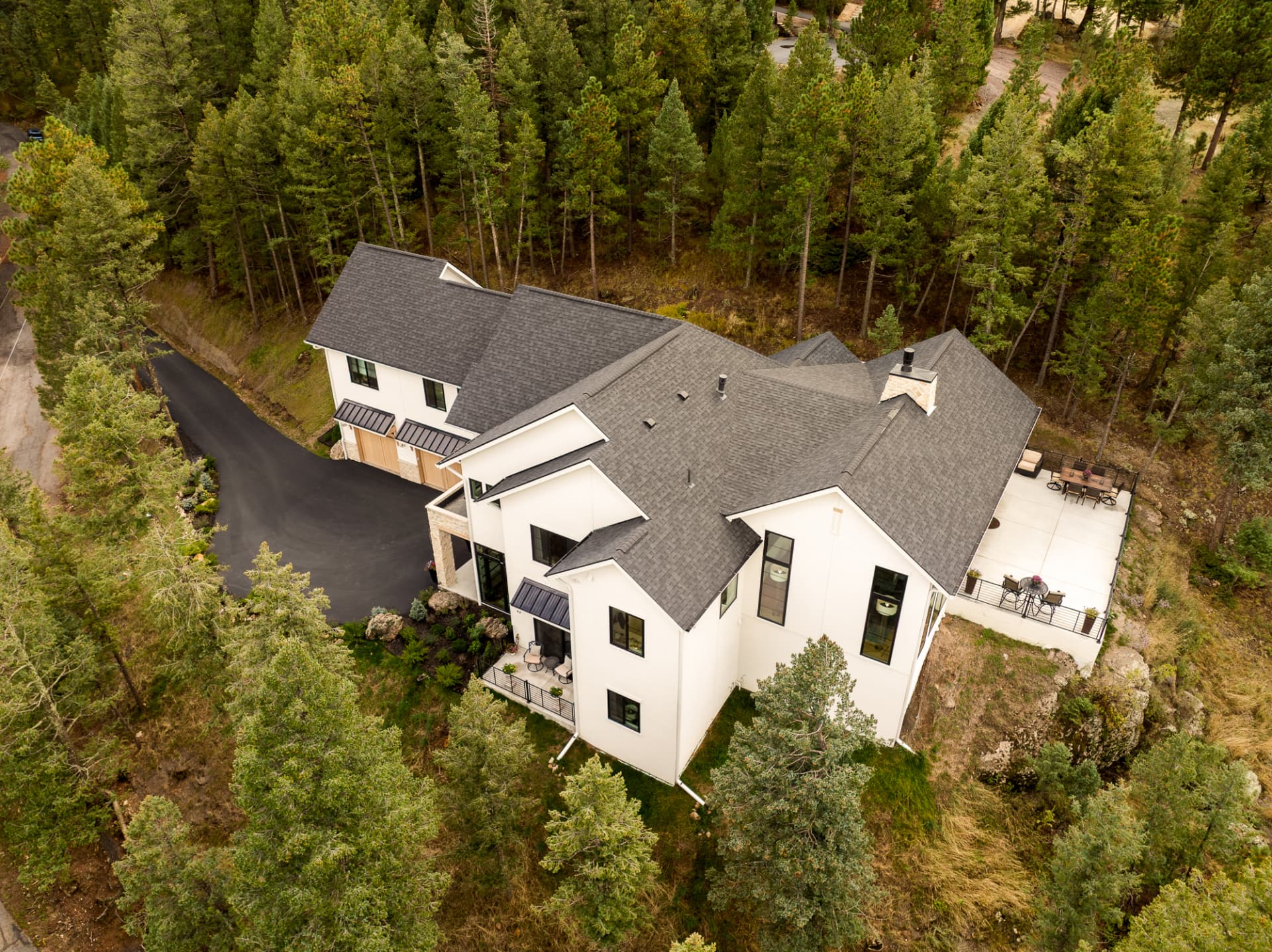 Aerial view of the Evergreen Home surrounded by pine trees