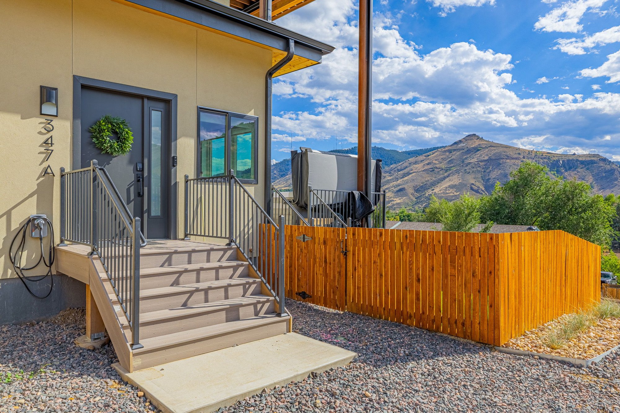 Lower patio and cedar privacy screen at the base of the house