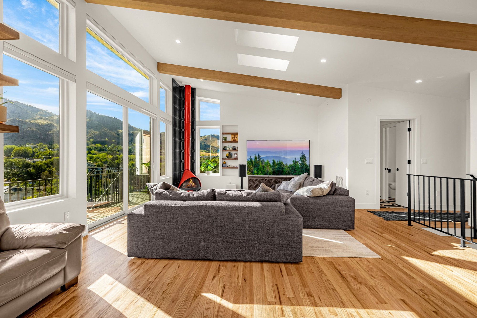 Wide view of the living room, stair rail and clerestory windows