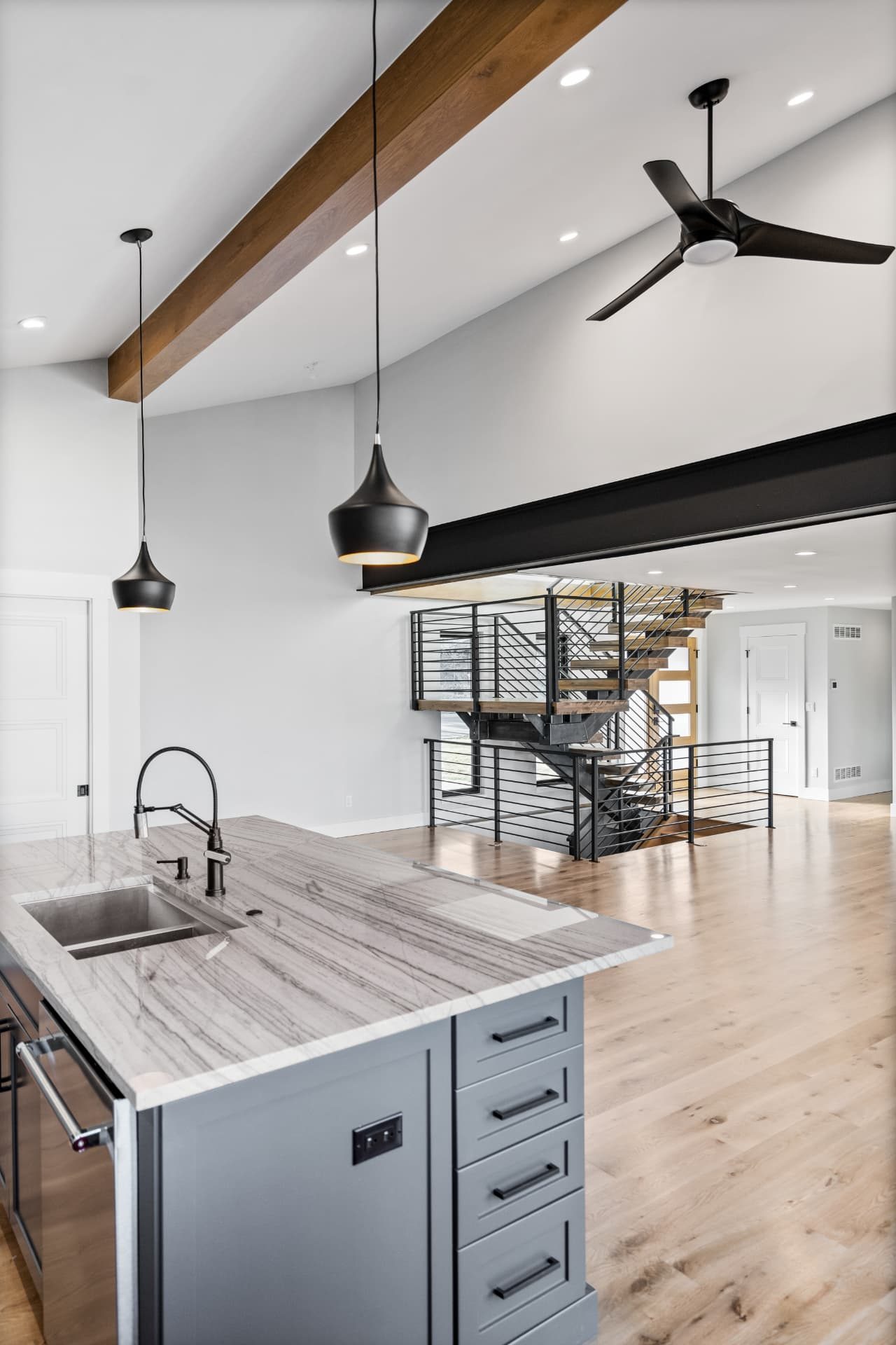 Kitchen and open plan living area under the vaulted ceiling and exposed beam