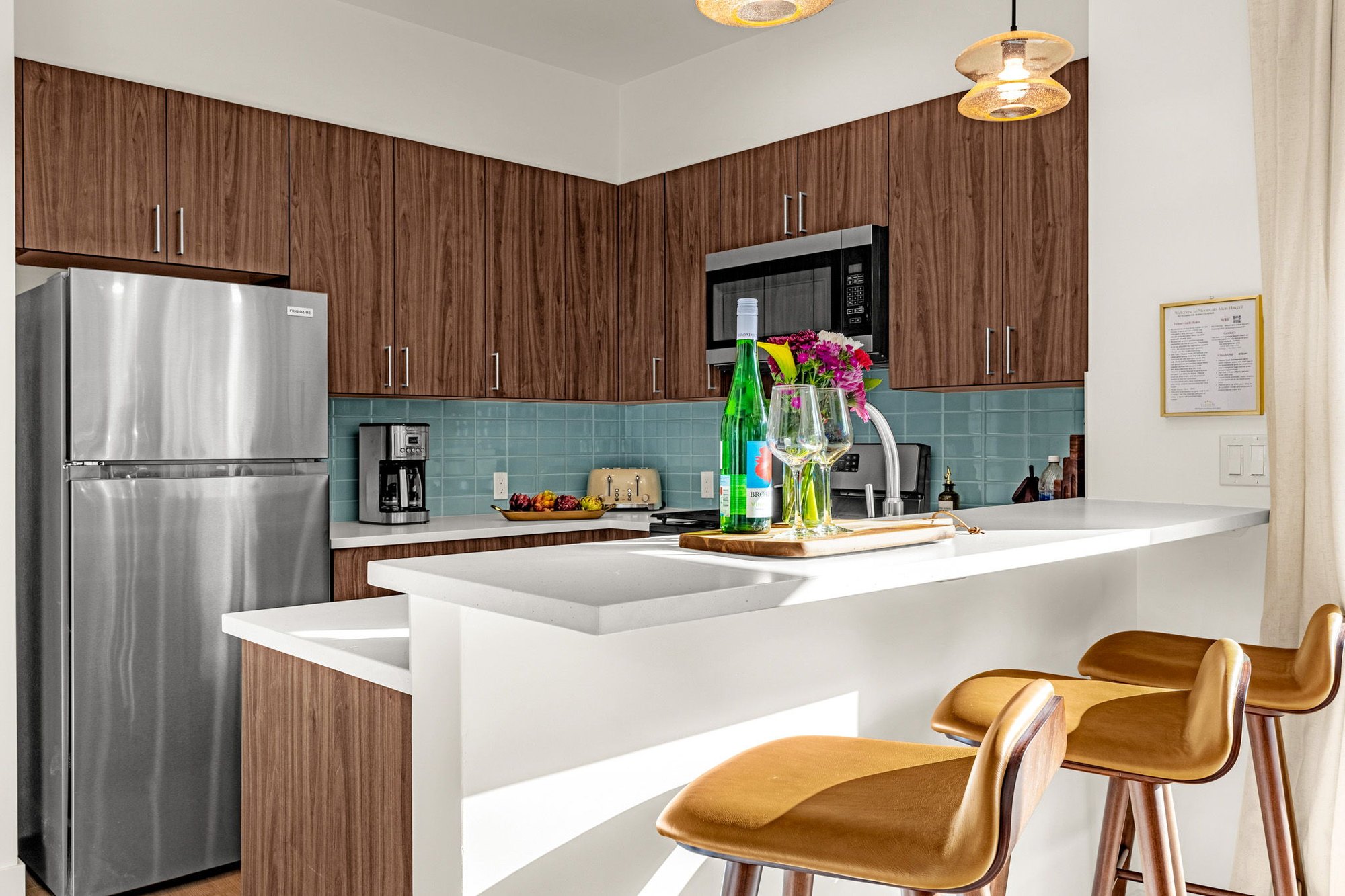 Lower unit kitchen with a peninsula and light tile backsplash
