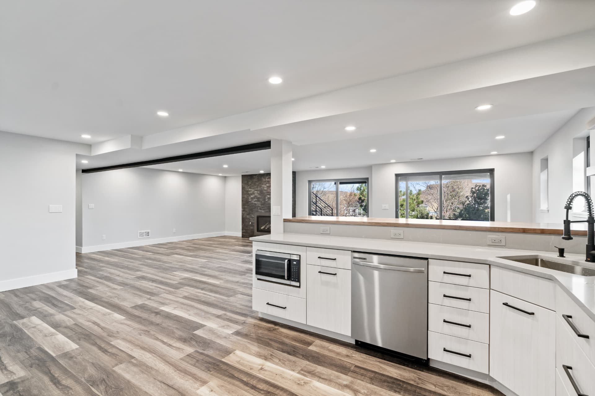 Open-plan kitchenette and living area with an exposed steel beam