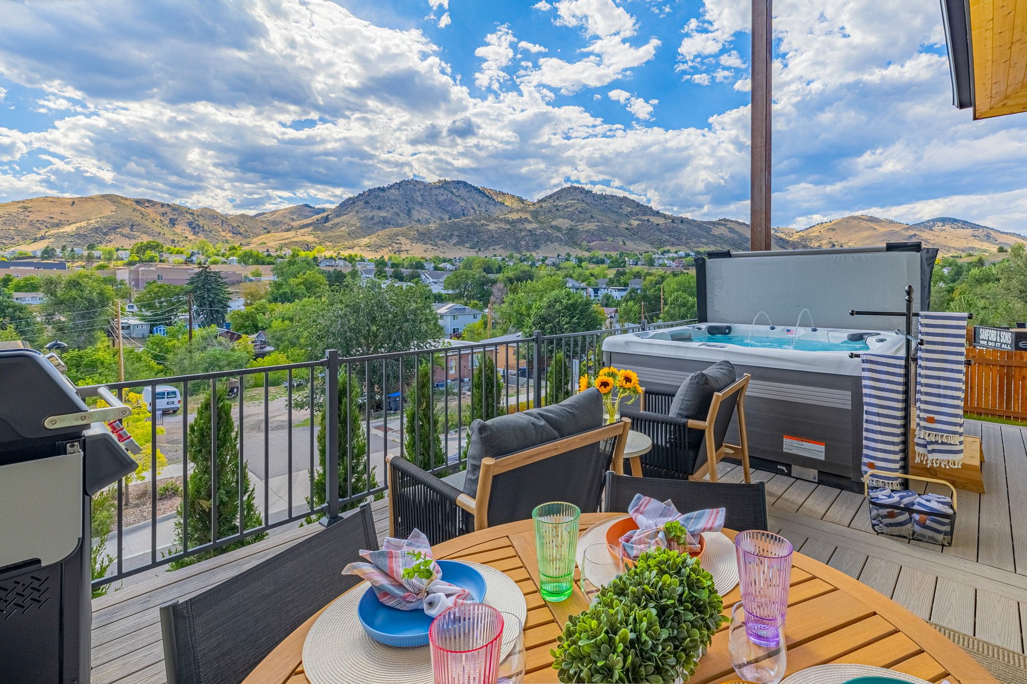 Composite deck with outdoor dining, hot tub and a view across Golden to the foothills