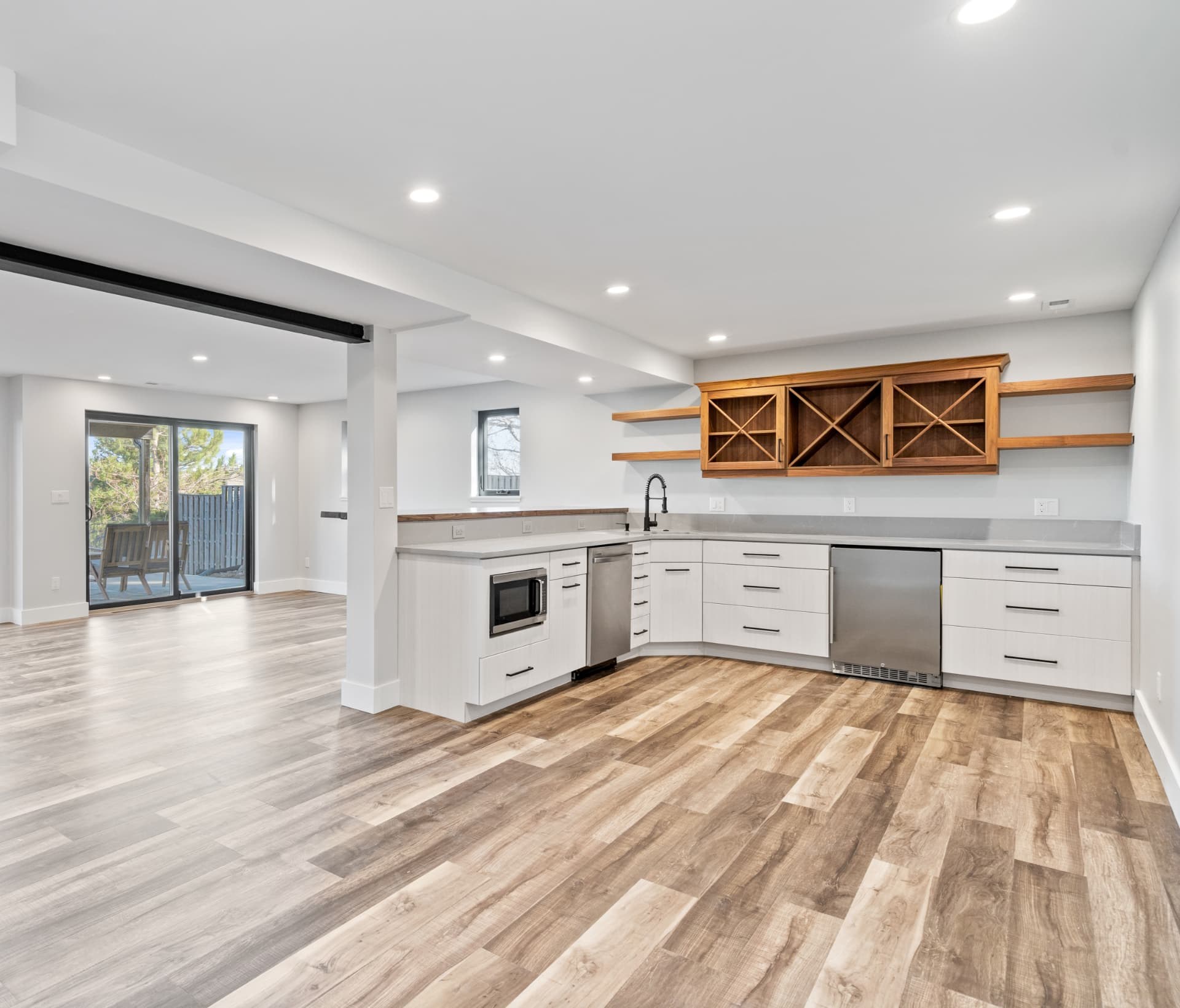 Wide view of the lower-level kitchenette and open living space