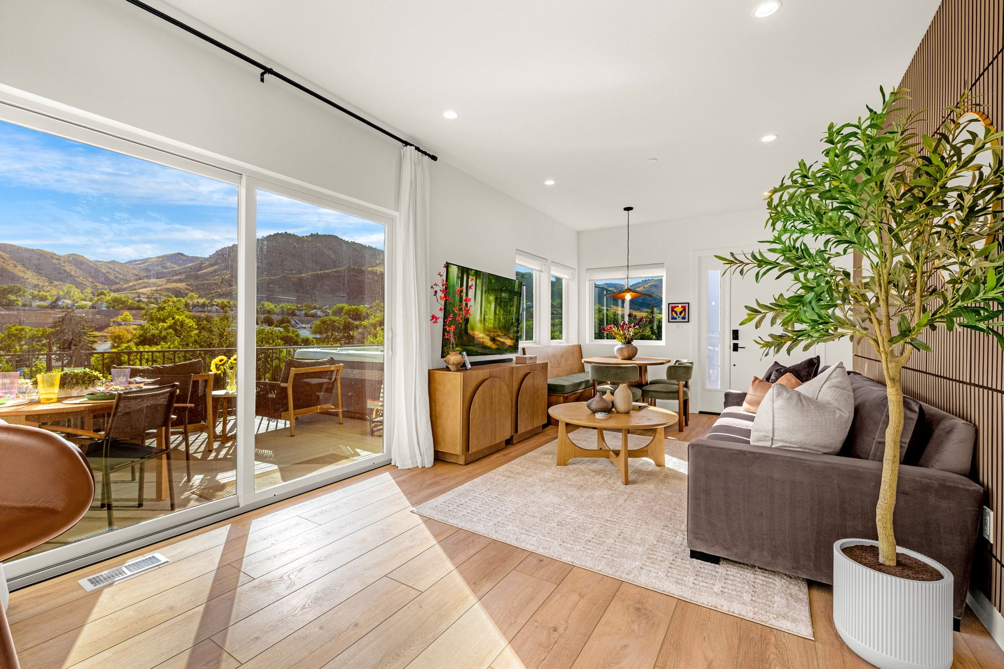 Open living and dining room in the lower unit with sliding glass doors to the deck